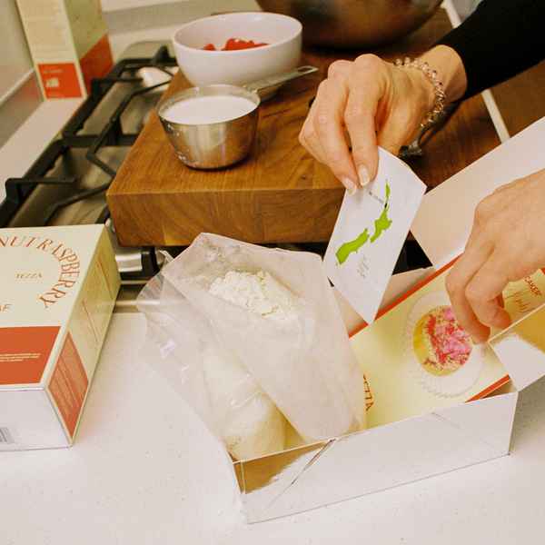 Coconut Raspberry Lime Leaf Cake KitEditorial Image of person making cake