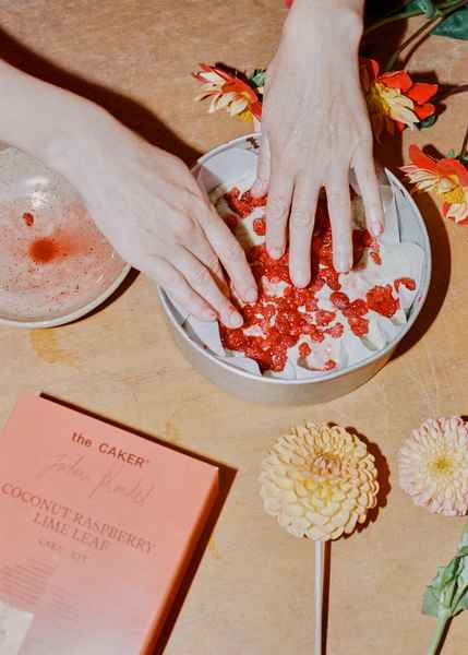 Coconut Raspberry Lime Leaf Cake KitEditorial Image of person making cake