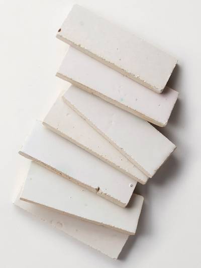 clé tile terracotta mochi white 2x6 tiles scattered in a row across the image

