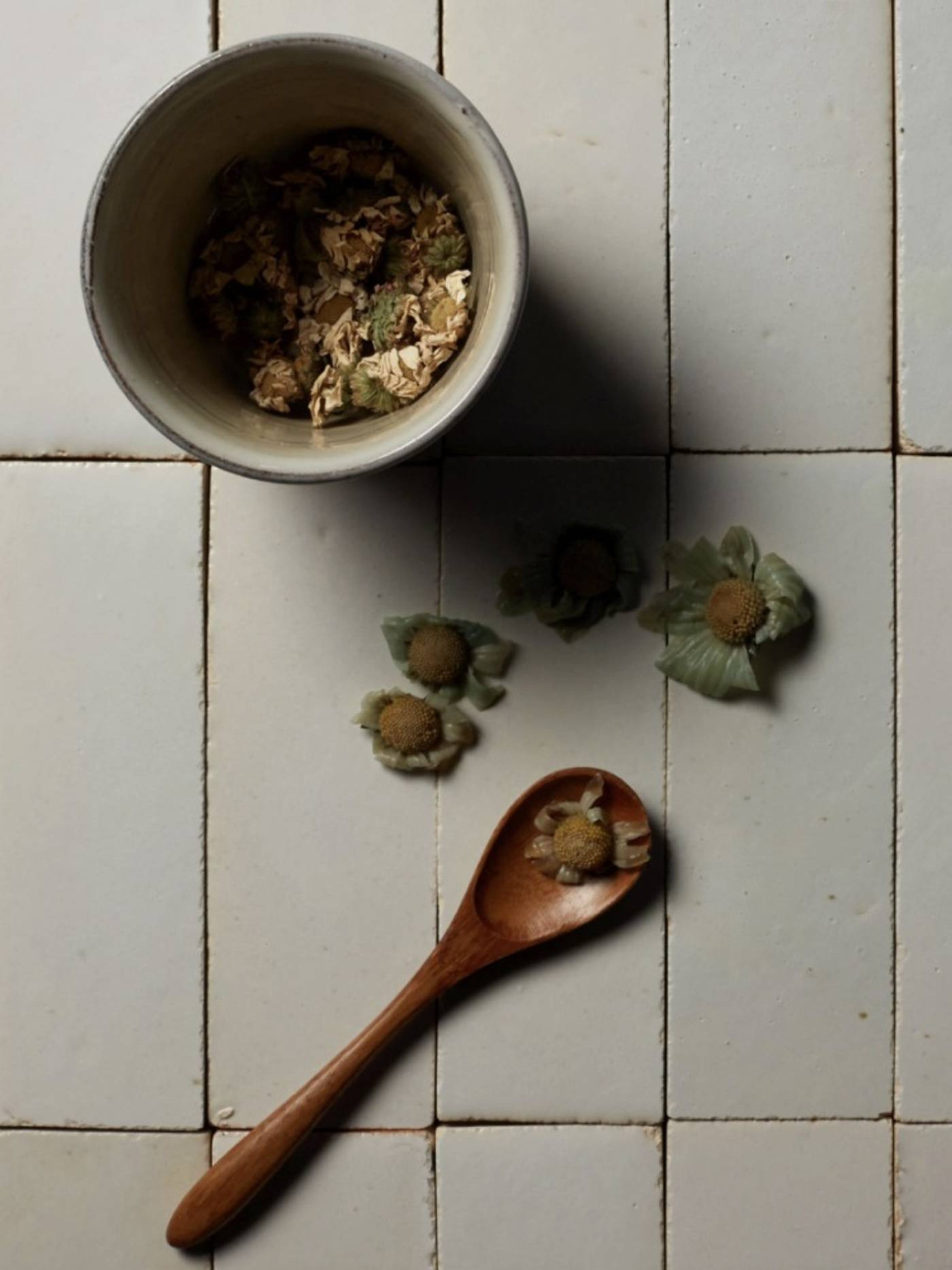  clé tile terracotta mochi white tiles laid out with a tea pot and chrysanthemum flowers strewn across