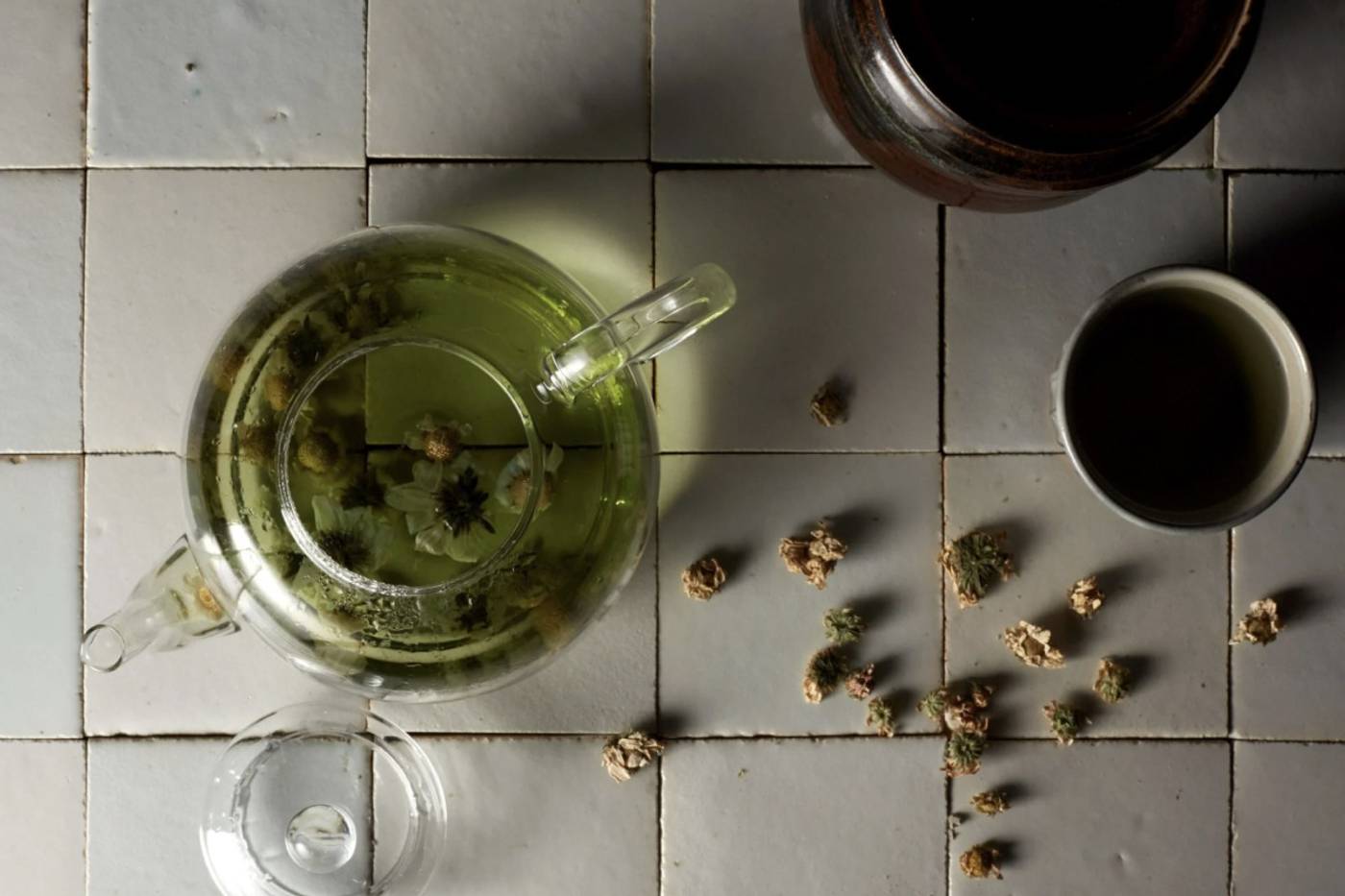  clé tile terracotta mochi white tiles laid out with a tea pot and chrysanthemum flowers strewn across