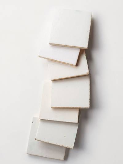  clé tile terracotta mochi white tiles scattered in a row across the image