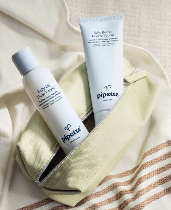 Lifestyle of Body + Belly Care Duo, Belly Butter & Belly Oil Inside Toiletry Bag. Purple Bottle of Belly Butter 3.8 fl oz, Purple Bottle of Belly Oil 4 fl oz and green Toiletry Bag.
