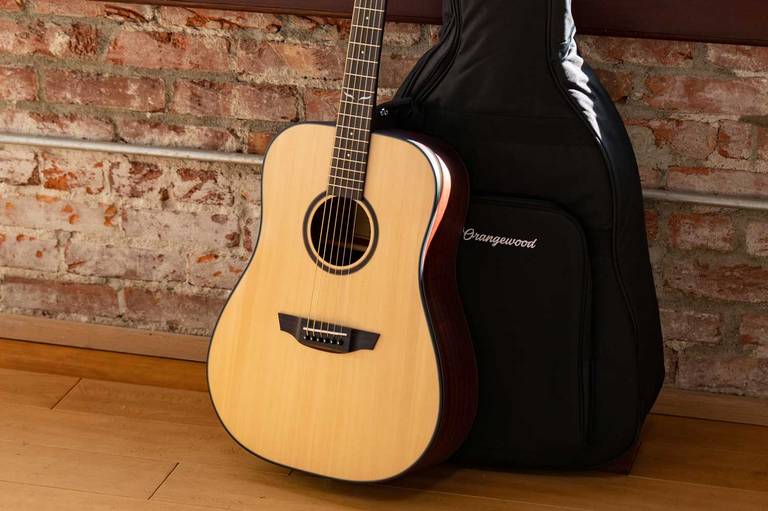 Austen guitar in front of an Orangewood gig bag