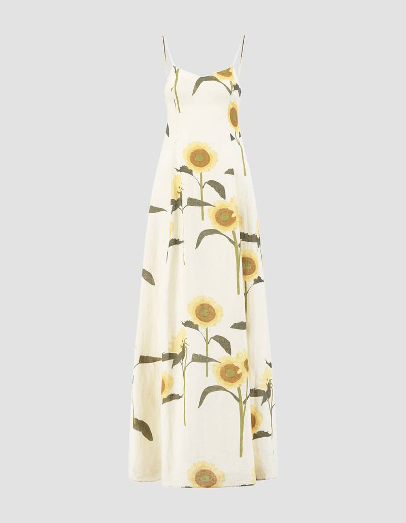 Bernadette Antwerp linen dress Aria. Printed with sunflowers, featuring spaghetti straps that flow into a grand gown.
