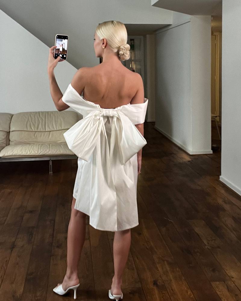 Bernadette Antwerp taffeta Sacha dress. Short ivory dress featuring bow in the back and corsage rose on the sweetheart neckline.