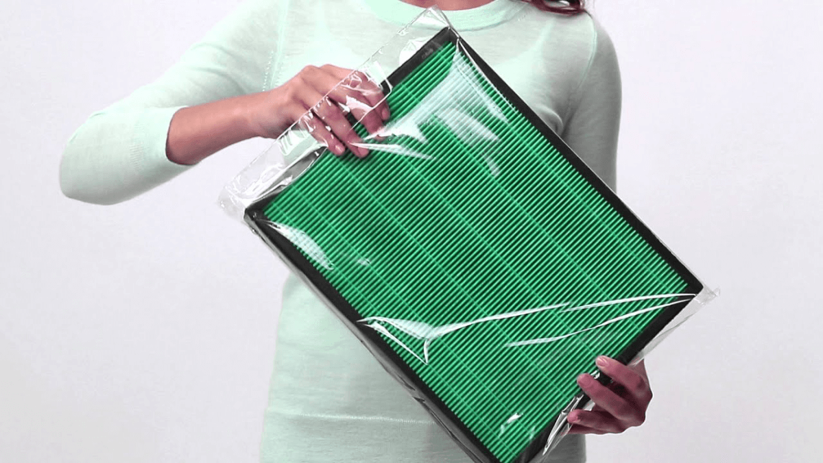 Women opening a packaged Airmega 240 Max2 Filter set