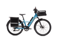 Blue Radster Road electric commuter bike in size Large with a hardshell locking pannier, front basket with basket bag, mirror and phone mount installed.