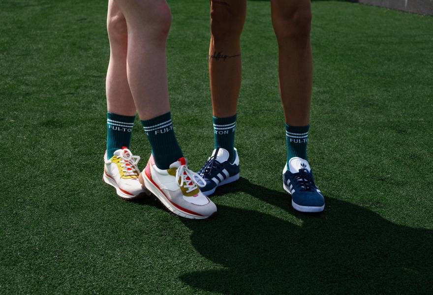 two people wearing green socks 