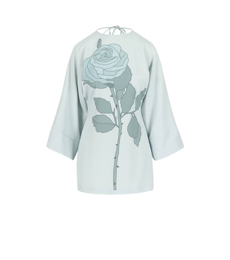 Bernadette Antwerp short dress Emmanuelle has a big rose on the front and is in the color blue. Featuring an open back and long sleeves. 