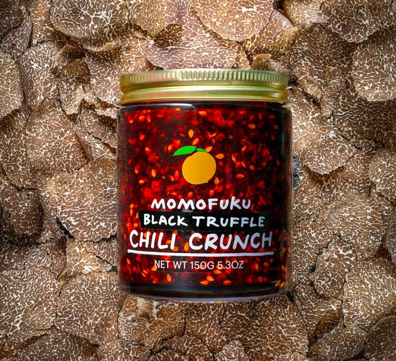jar of black truffle chili crunch on a bed of truffles
