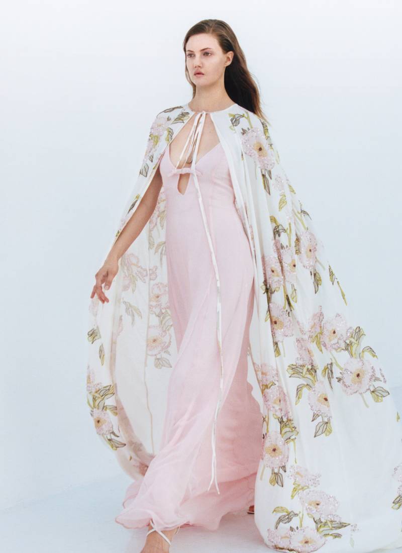 Bernadette Antwerp dress Mavis is made form silk and features a v-neckline with spaghetti straps and a bow, flowing into a floor-length gown. Color blush pink.  Model Lindsey Wixson.