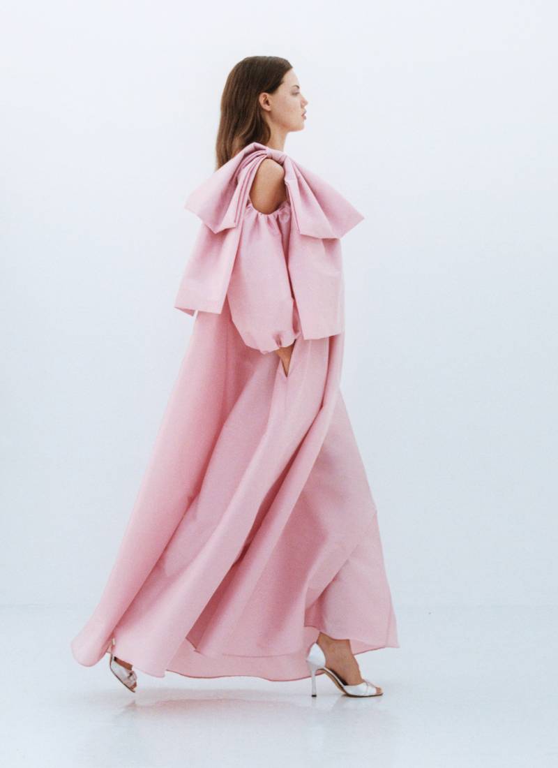 Bernadette Antwerp dress Victoria is a floor length gown made from taffeta fabric, featuring the signature BERNADETTE bow detail, poofy sleeves and a crew neckline. This evening wear dress is in the color warm pink. Model Lindsey Wixson.