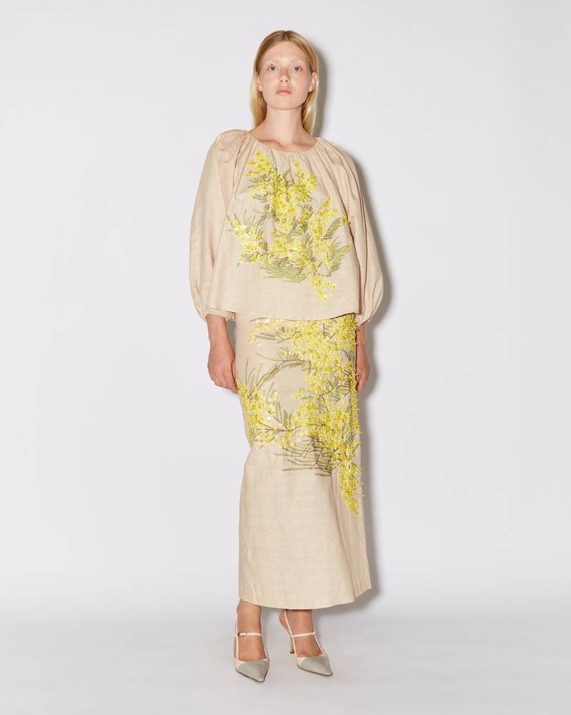 Bernadette Antwerp skirt Norma is an ankle-length pencil skirt made from linen fabric and adorned with hand-embroidered mimosa print on a beige base.