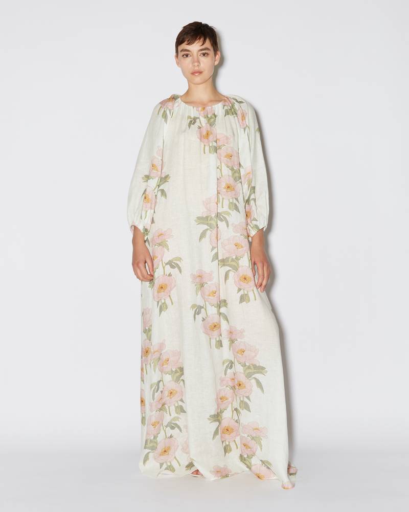 Bernadette Antwerp dress Georgina is a floor length linen gown adorned with the Big Peonies print on a white / ivory base, featuring a crew neckline and long poofy sleeves that flows into a voluminous dress. 