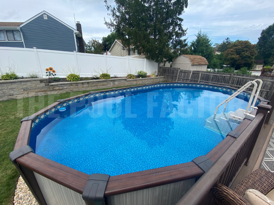 Oval above ground swimming pool with a privacy fence surrounding property