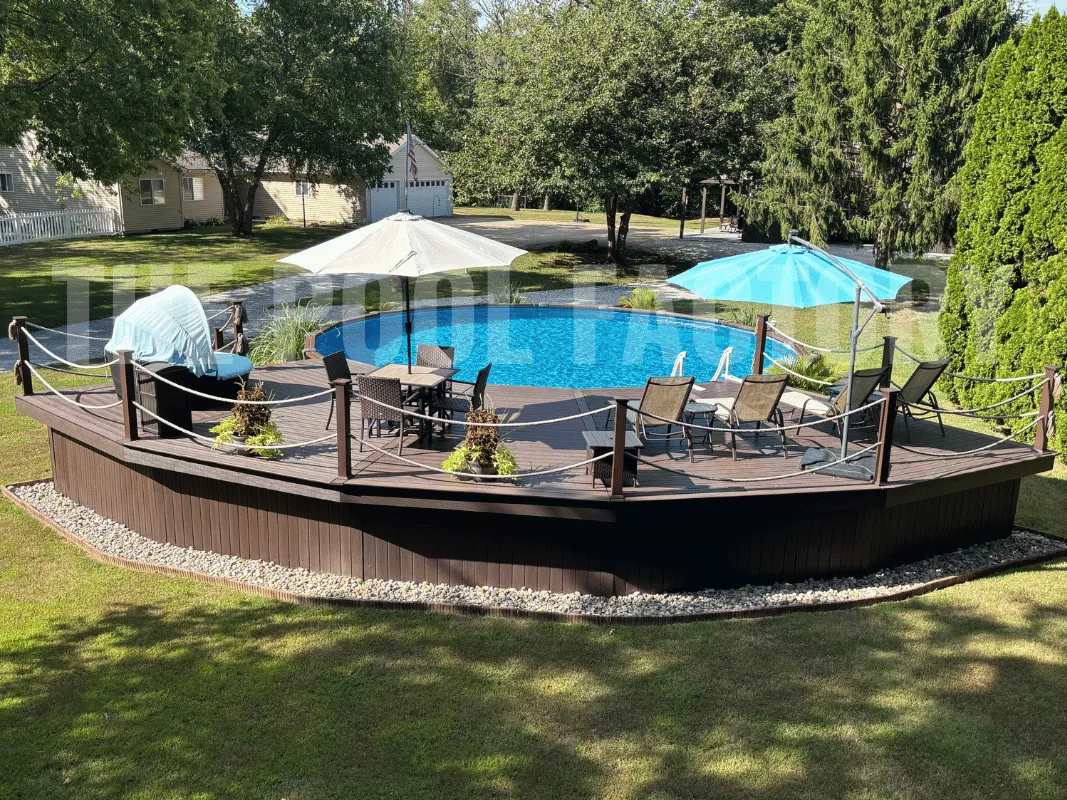 Round above ground pool with deck, outdoor furniture, and umbrellas