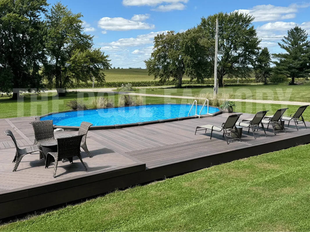 Oval above ground pool with wraparound deck and comfortable loungers