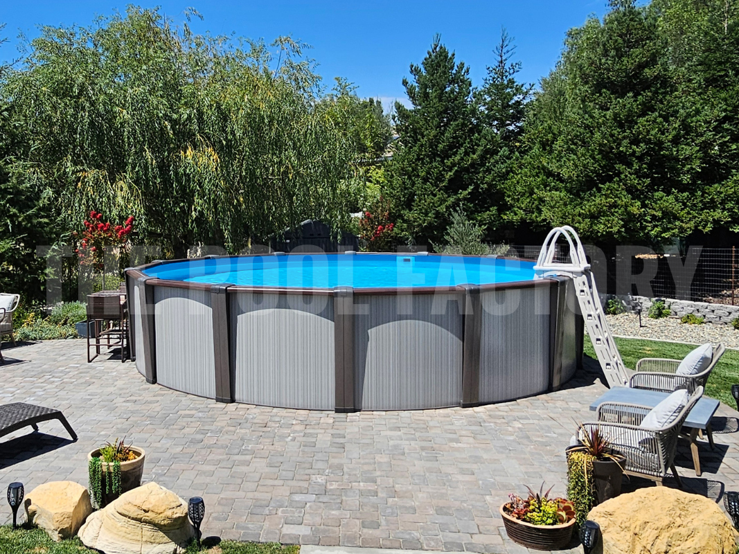 Above ground swimming pool with stone patio, comfy lounge chairs surrounded by lush greenery and a sunny garden