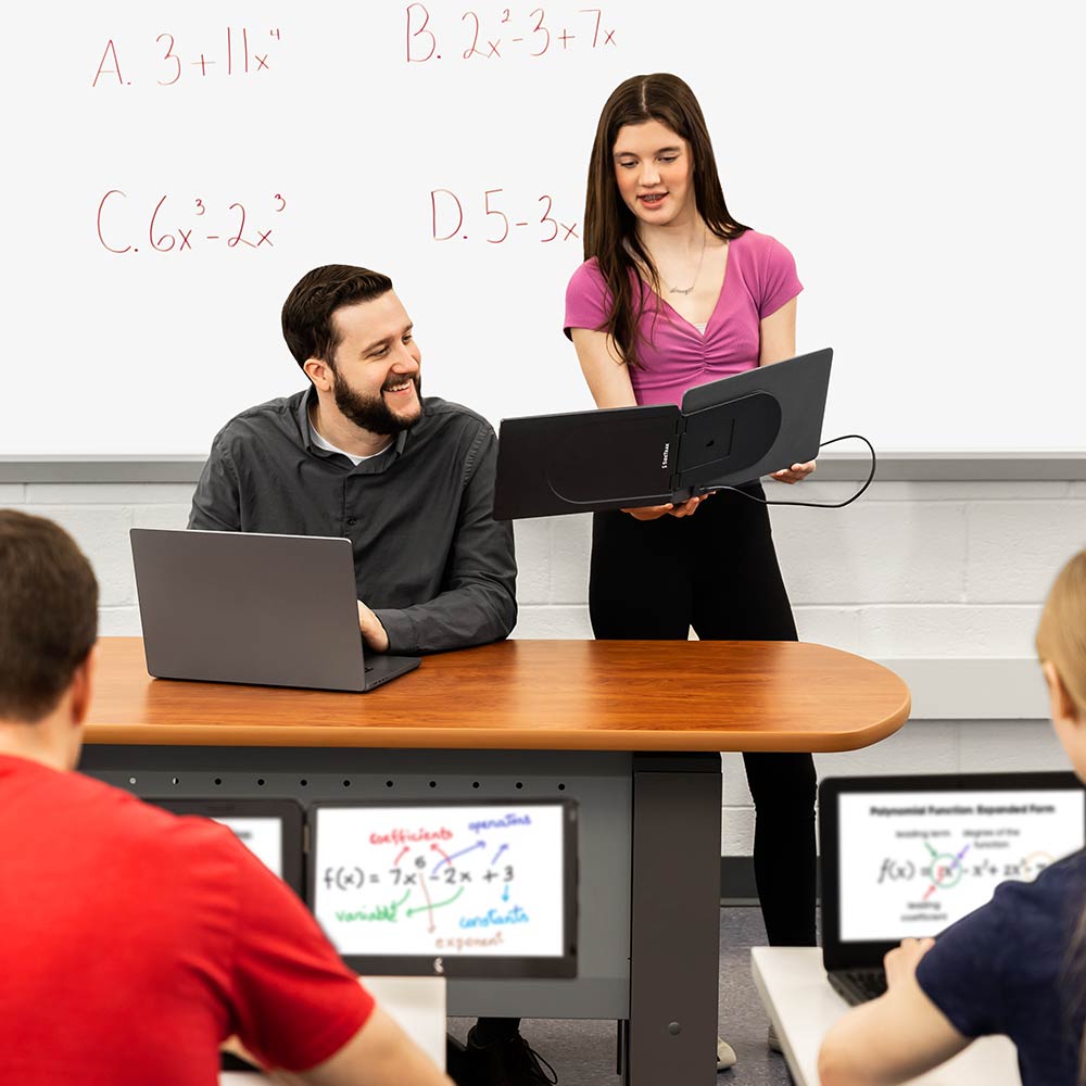 Photo of a student and teacher collaborating on the student's SideTrak Swivel Essential portable monitor