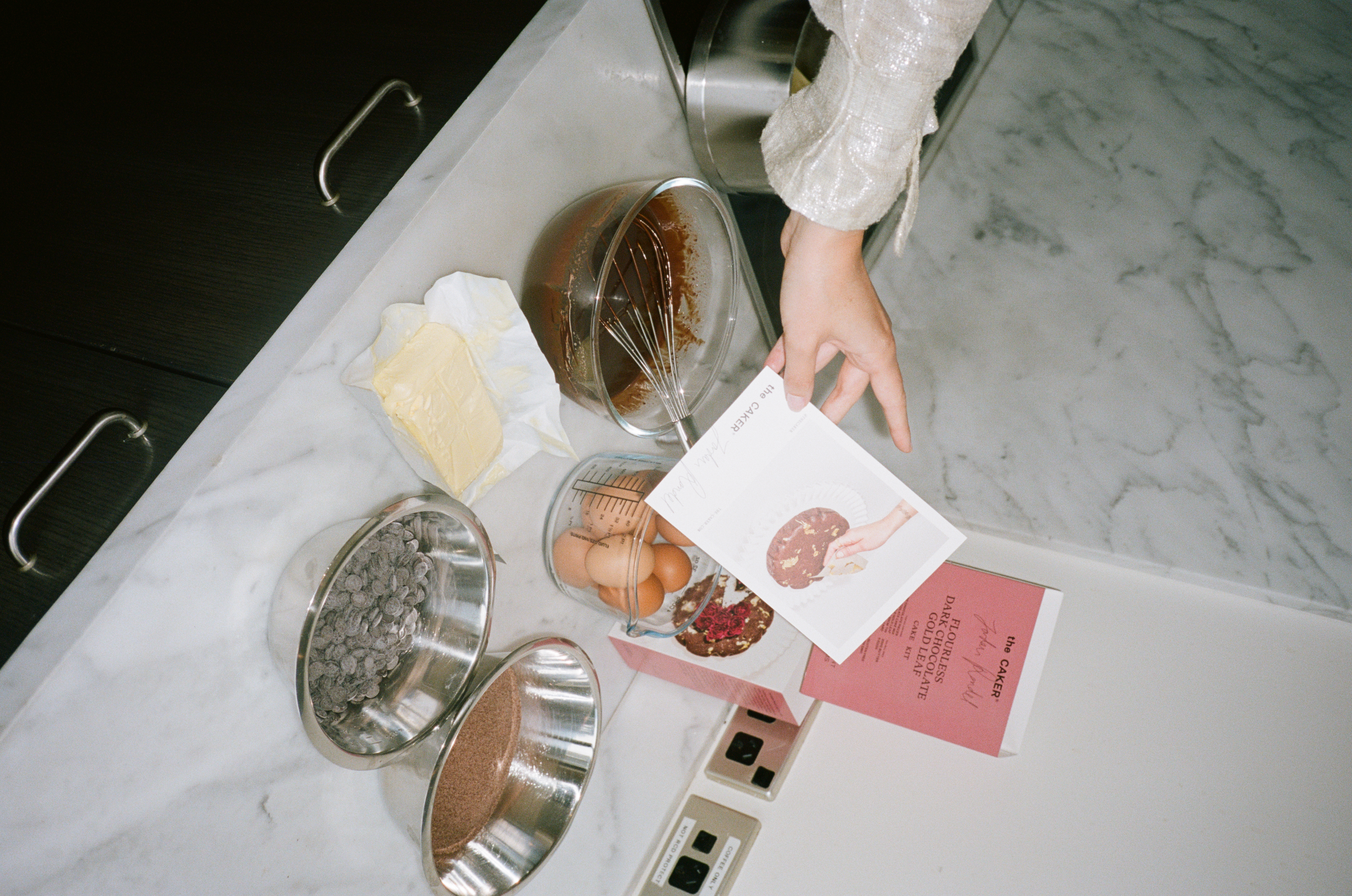 Flourless Dark Chocolate Gold Leaf Cake KitEditorial Image  of person making cake