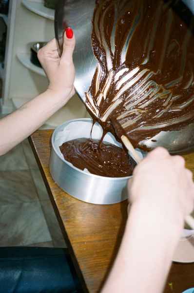 Flourless Dark Chocolate Gold Leaf Cake KitEditorial Image of person making cake