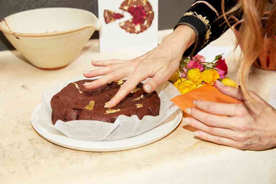 Flourless Dark Chocolate Gold Leaf Cake KitEditorial Image  of person making cake