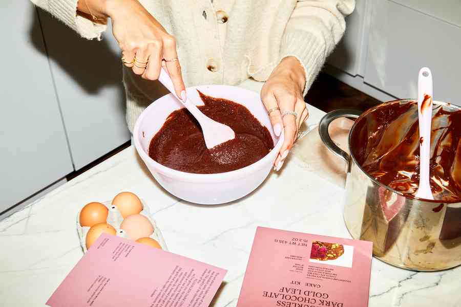 Flourless Dark Chocolate Gold Leaf Cake KitEditorial Image  of person making cake