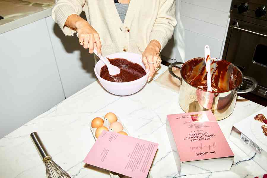 Flourless Dark Chocolate Gold Leaf Cake KitEditorial Image  of person making cake