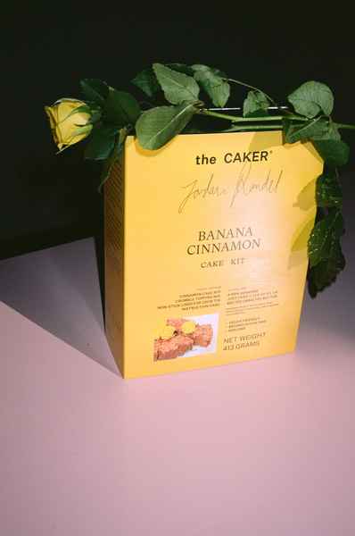 WHOLESALE Banana Cinnamon Cake Kit - (6 Unit Case)Editorial Image of person making cake