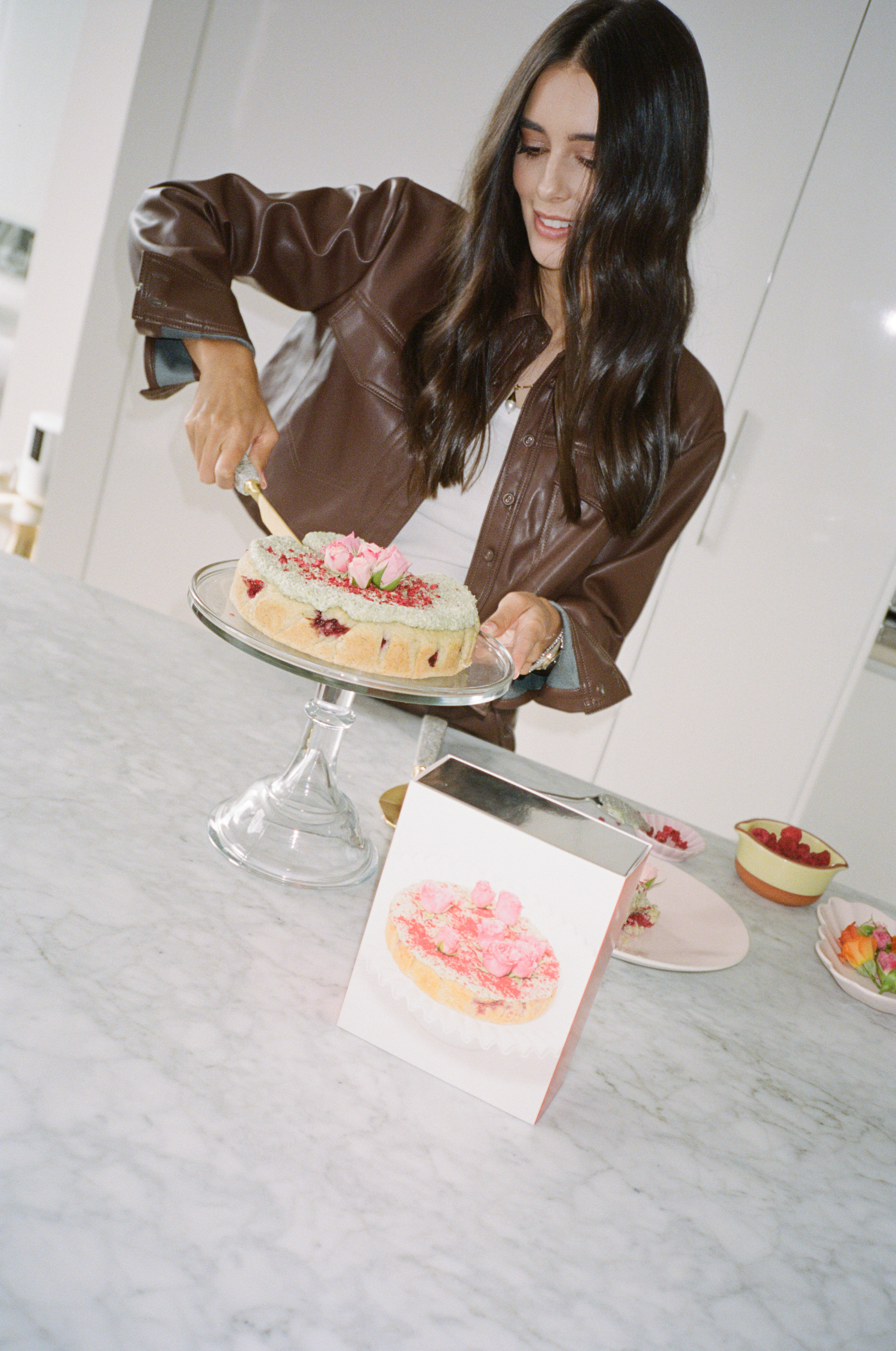 Coconut Raspberry Lime Leaf Cake KitEditorial Image of person making cake