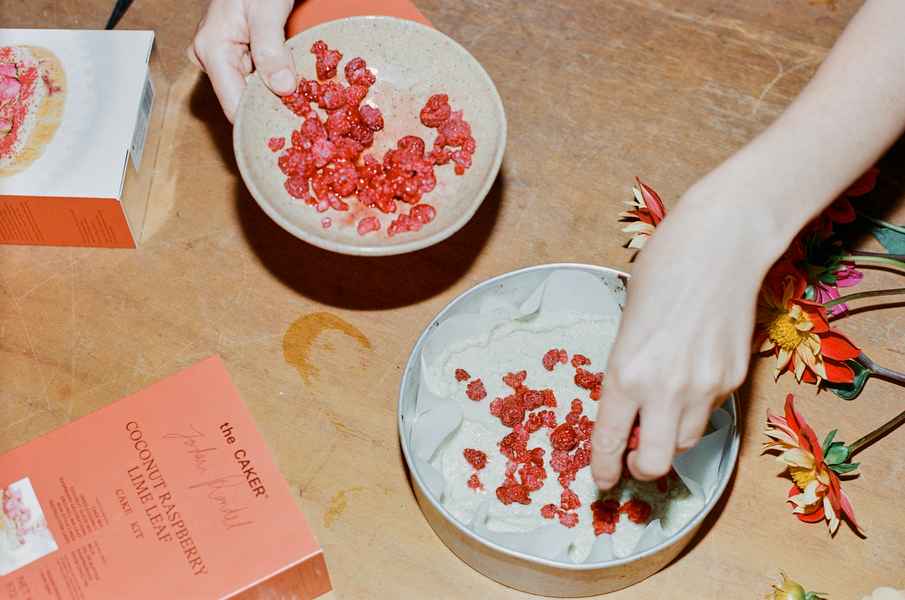 Coconut Raspberry Lime Leaf Cake KitEditorial Image of person making cake