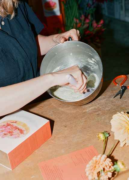 Coconut Raspberry Lime Leaf Cake KitEditorial Image of person making cake