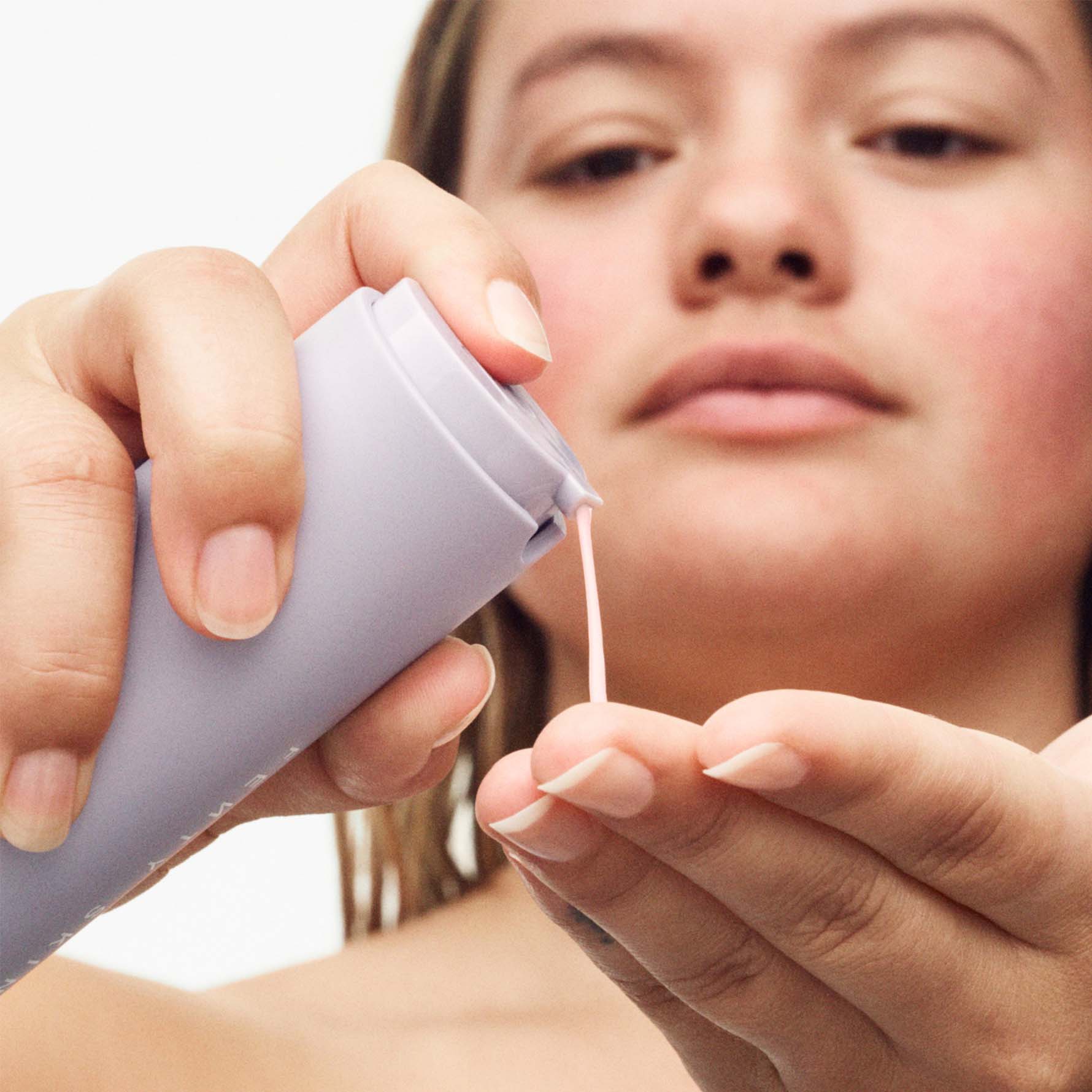 Model squeezing Hydra Vizor Moisturizer into hands, Model squeezing Hydra Vizor Moisturizer into hands,