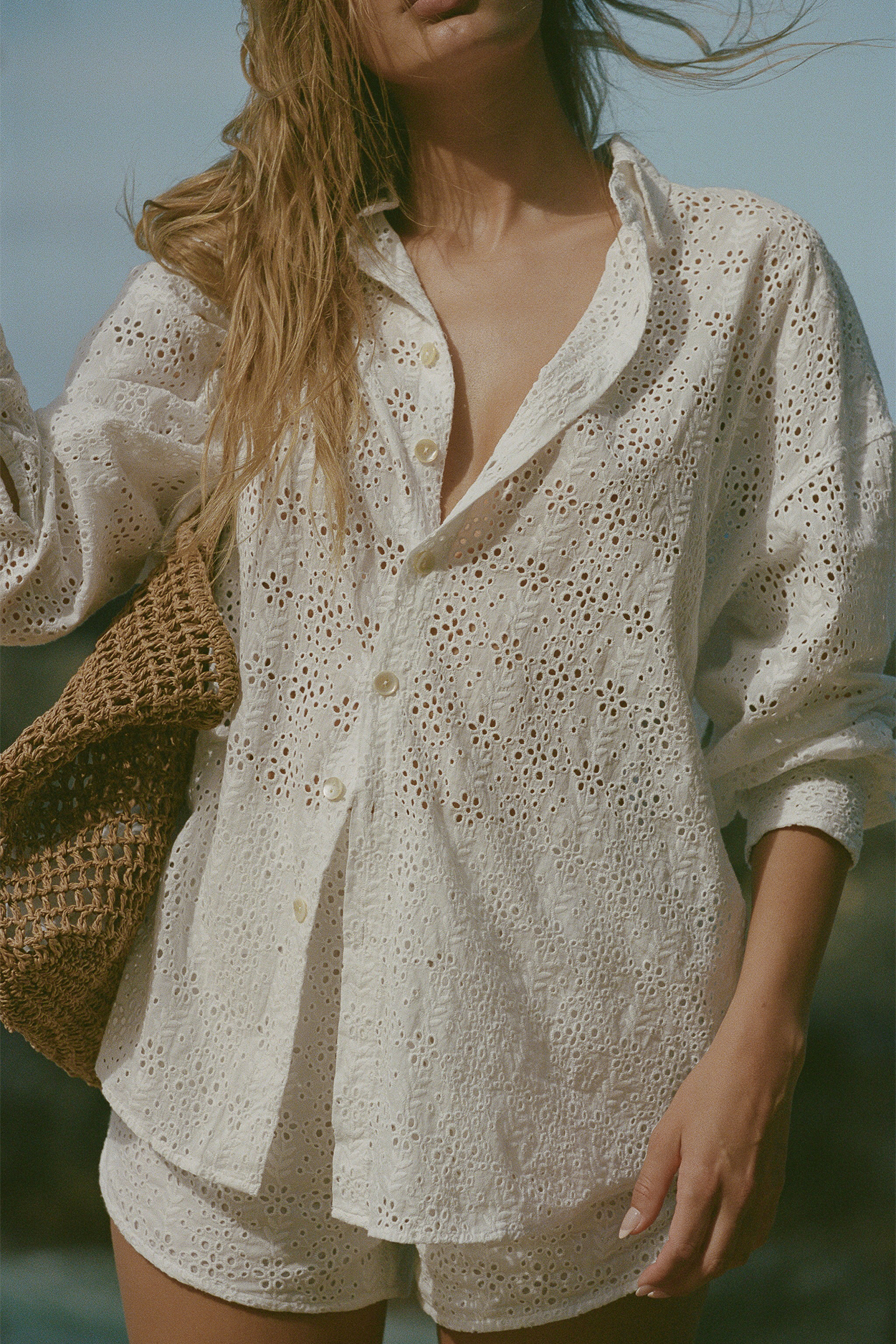 Model posing in Playa Organic Cotton Oversized Shirt - White Eyelet Fabric - Front