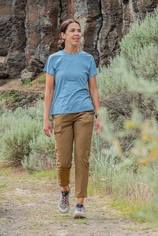 Women on a trail hike while wearing the Tinkham trail pant and the Feathers Tech-T by Beyond Clothing.