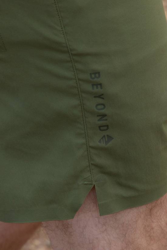 Close up shot of the Evergreen colored TarnGood short focusing on the Beyond logo on the side vent. 