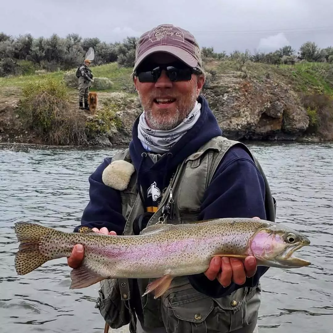 Man with Rainbow Trout Caught on a Fly Rod