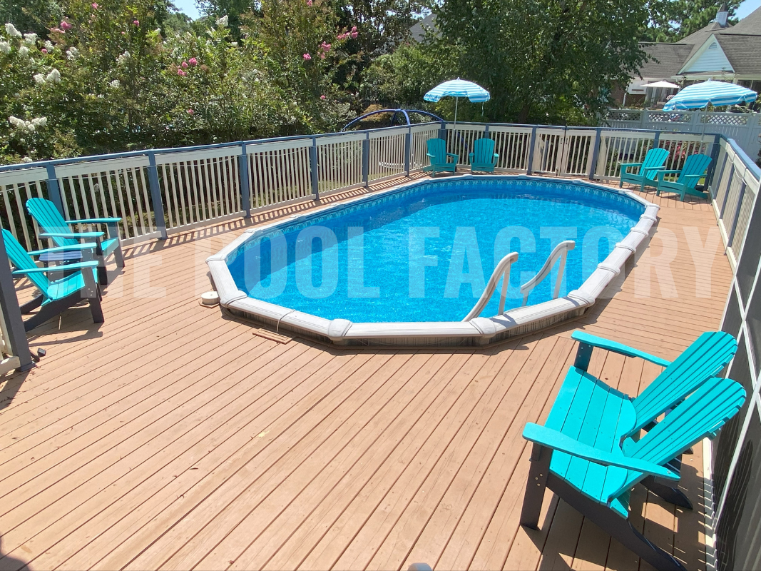 Oval swimming pool with full deck, and lounge chairs on a sunny day