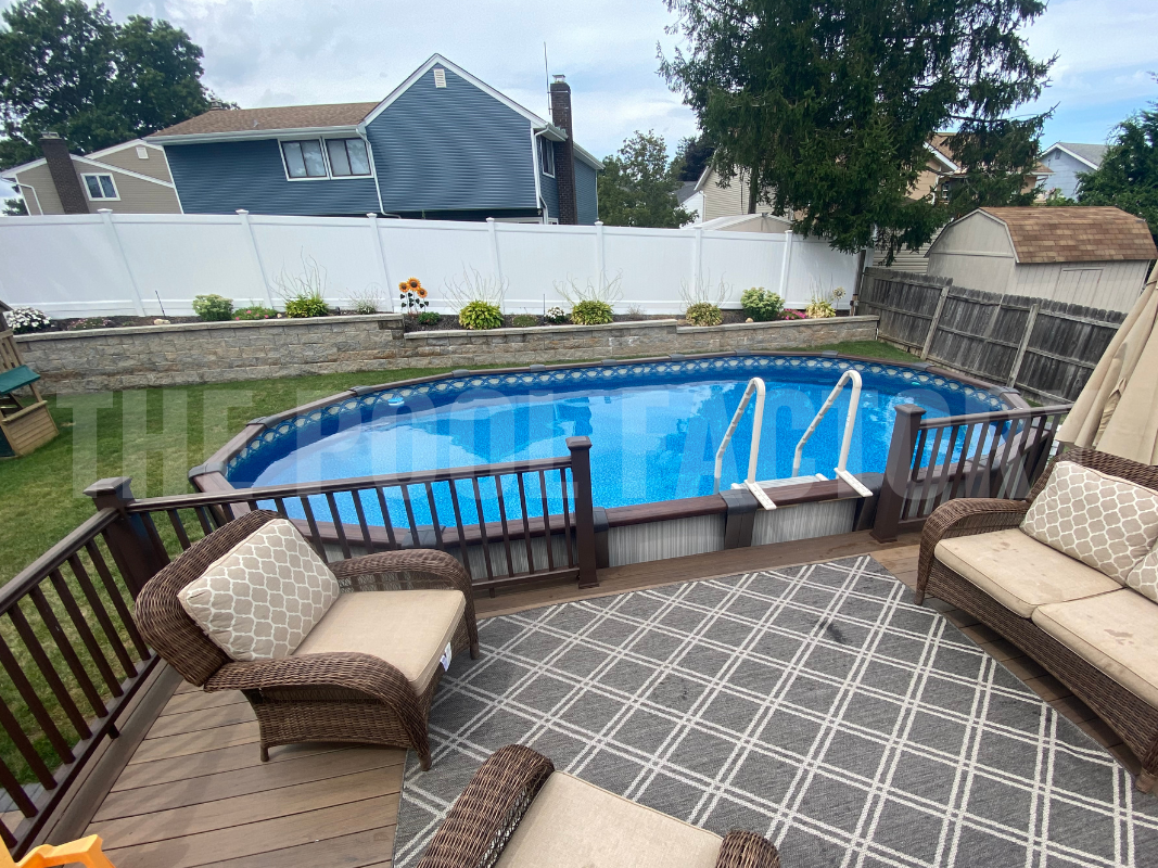Oval above ground swimming pool with a small deck for easy access