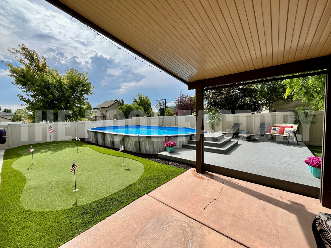 Oval swimming pool with deck, putting green, and gazebo