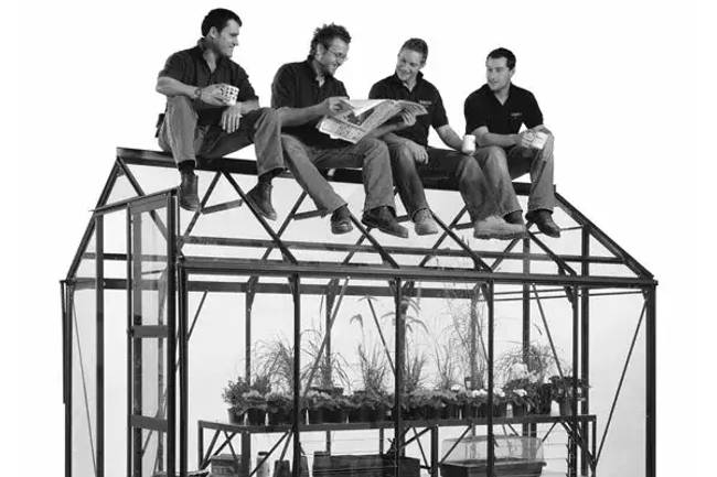 4 men sitting on a Rhino Greenhouse