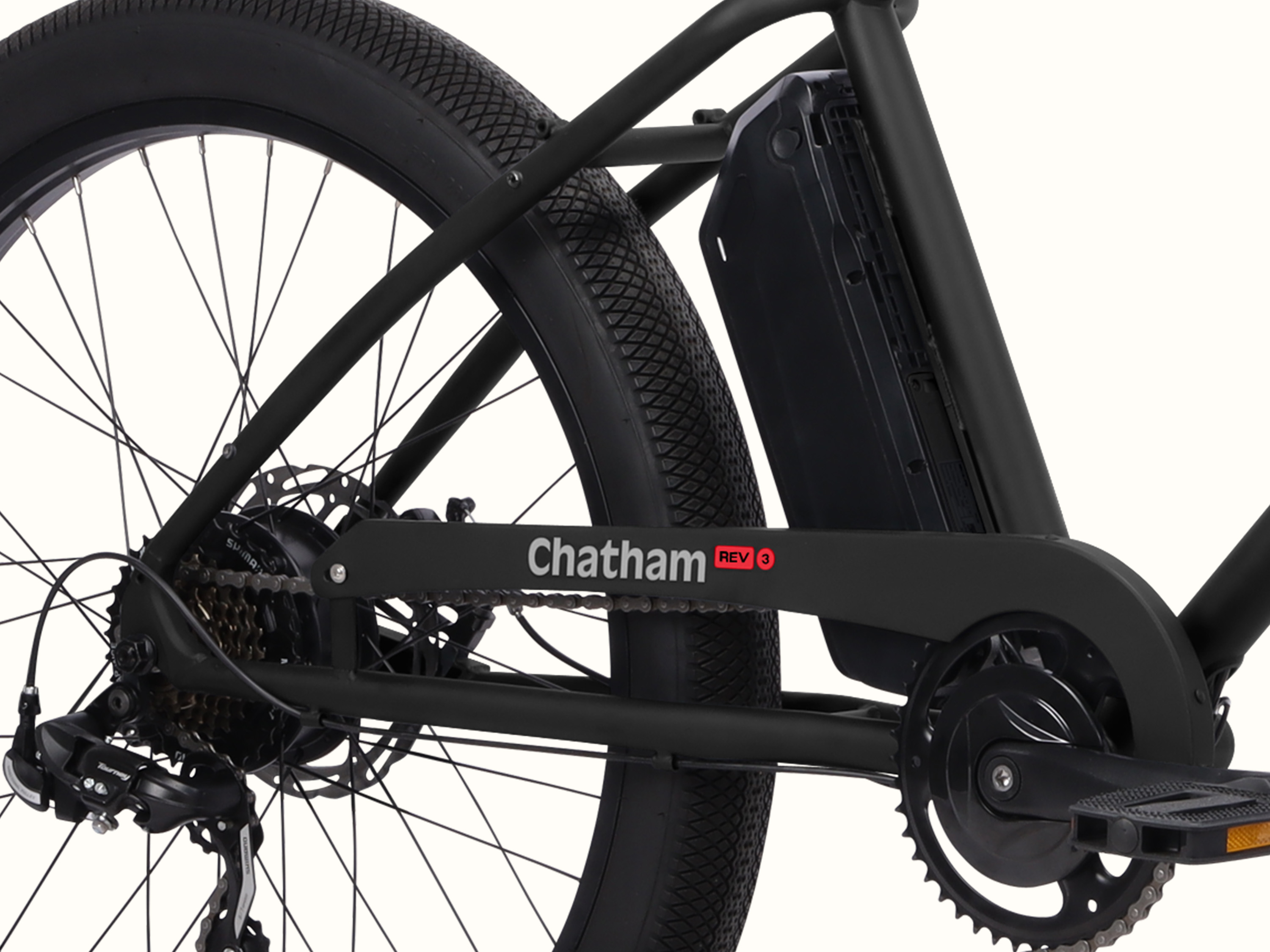 Close-up of the Chatham Rev 3 Beach Cruiser Electric Bike's battery and rear wheel.