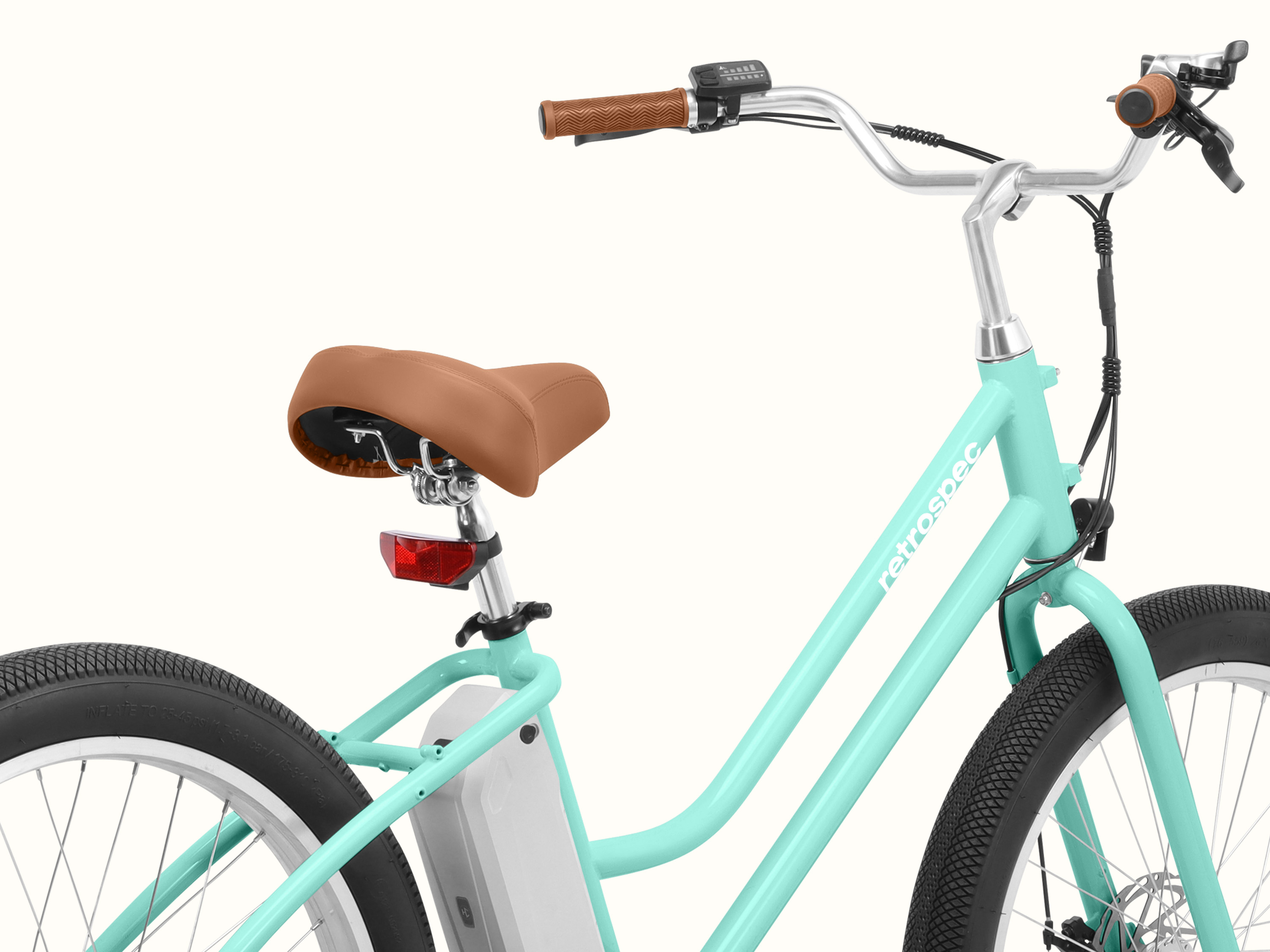 A close-up of the Seafoam Chatham Rev 3 Beach Cruiser Electric Bike's frame and saddle.