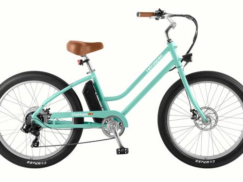 Mint green electric beach cruiser bicycle with brown saddle, black tires, and no background.