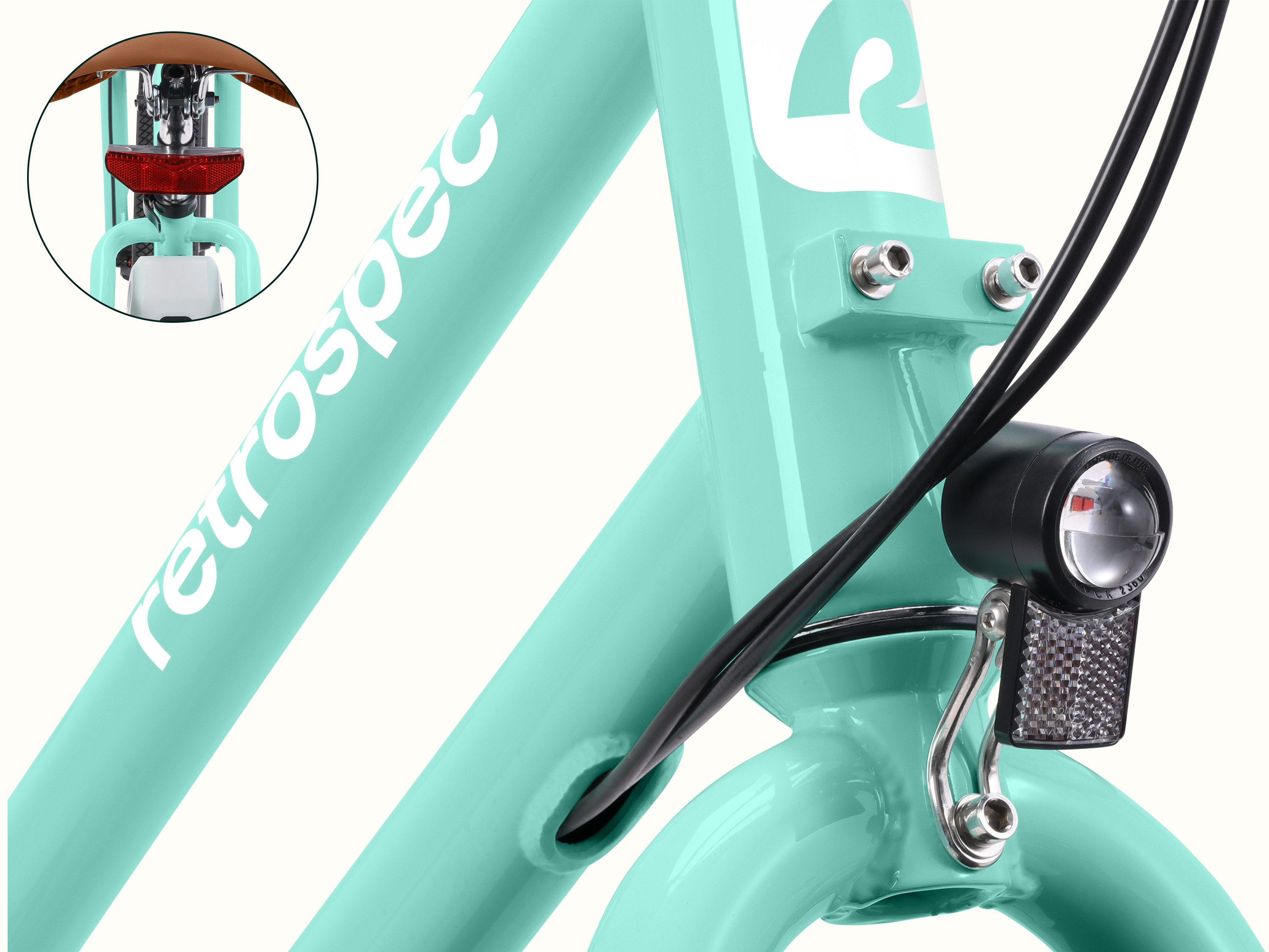 A close-up of the Seafoam Chatham Rev 3 Beach Cruiser Electric Bike's headlight and taillight.