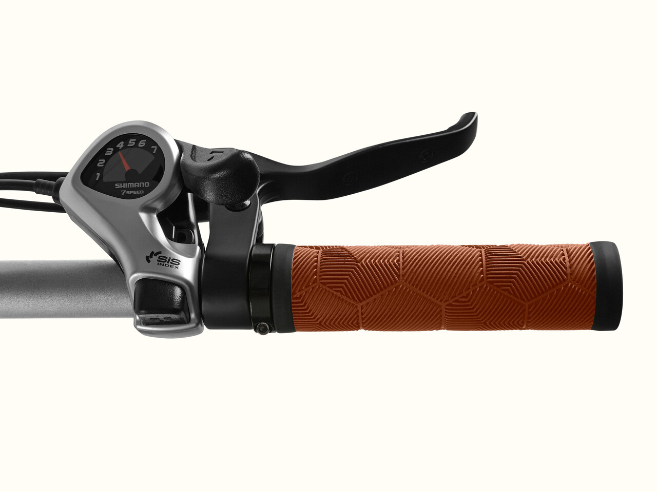 Close-up of the Chatham Rev+ 2 Beach Cruiser Electric Bike's handlebars featuring a Shimano 7-speed gear shifter and textured brown grip.