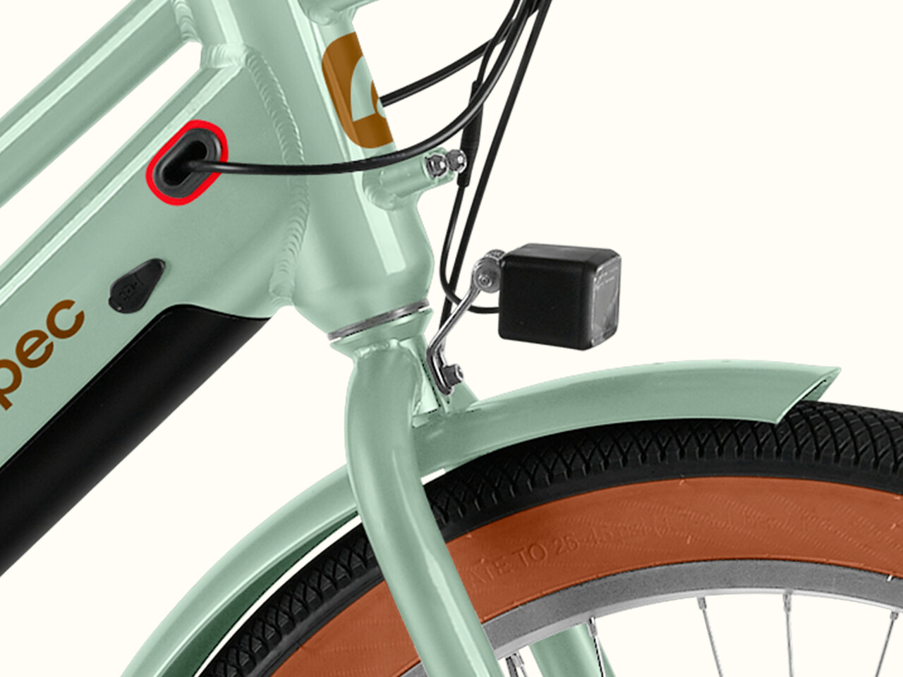 Close-up of a light green Chatham Rev+ 2 Beach Cruiser Electric Bike's frame featuring the front headlight, cable guide, battery pack, and a brown tire, emphasizing sleek design and technology.