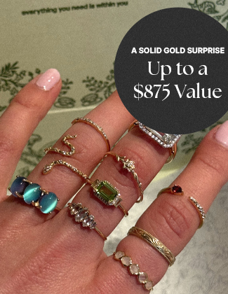 Several gold gemstone rings on a hand