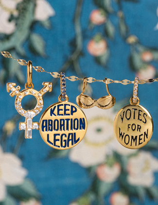 Four gold charms hanging from a chain in front of a blue floral backdrop